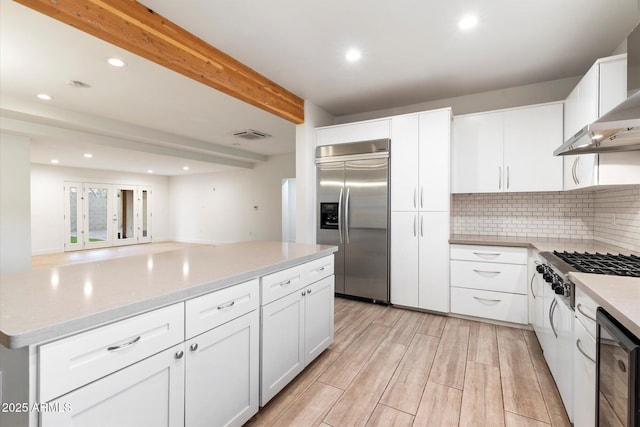 1801 E Berridge Ln, Phoenix, AZ 85016 - kitchen featuring appliances with stainless steel finishes, wall chimney range hood, recessed lighting, wine cooler, and backsplash