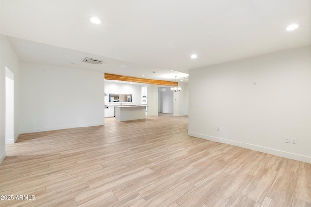 1801 E Berridge Ln, Phoenix, AZ 85016 - unfurnished living room with recessed lighting, a chandelier, light wood finished floors, and baseboards