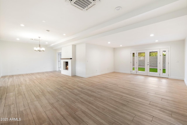 1801 E Berridge Ln, Phoenix, AZ 85016 - unfurnished living room featuring a chandelier, recessed lighting, light wood-style floors, baseboards, and french doors