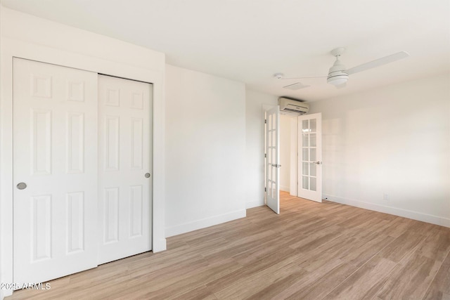 1801 E Berridge Ln, Phoenix, AZ 85016 - unfurnished bedroom with an AC wall unit, light wood-style flooring, baseboards, and a closet