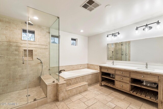 1801 E Berridge Ln, Phoenix, AZ 85016 - bathroom featuring a garden tub, a shower stall, double vanity, stone tile floors, and recessed lighting