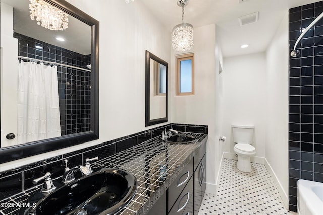 1801 E Berridge Ln, Phoenix, AZ 85016 - full bathroom with toilet, double vanity, and baseboards