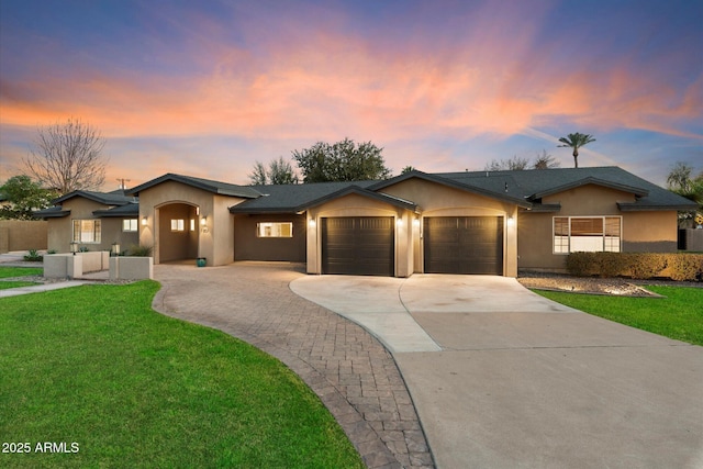 1801 E Berridge Ln, Phoenix, AZ 85016 - ranch-style home with an attached garage, stucco siding, driveway, and a lawn