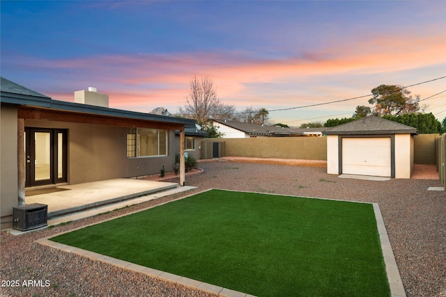 1801 E Berridge Ln, Phoenix, AZ 85016 - yard at dusk with a patio area, an outbuilding, and gravel driveway