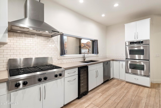 1801 E Berridge Ln, Phoenix, AZ 85016 - kitchen with wall chimney exhaust hood, stainless steel appliances, wine cooler, a sink, and white cabinets