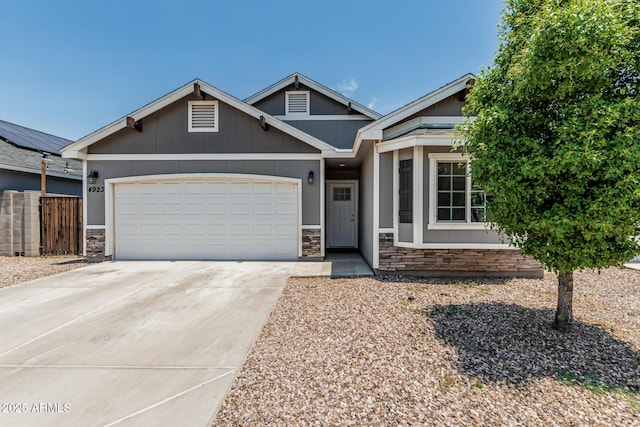 4923 S 11th Pl, Phoenix, AZ 85040 - view of front of home with stone siding, concrete driveway, and an attached garage