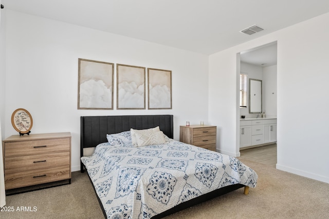 2204 E Kelly Dr, Gilbert, AZ 85298 - bedroom with ensuite bathroom, baseboards, light colored carpet, and visible vents