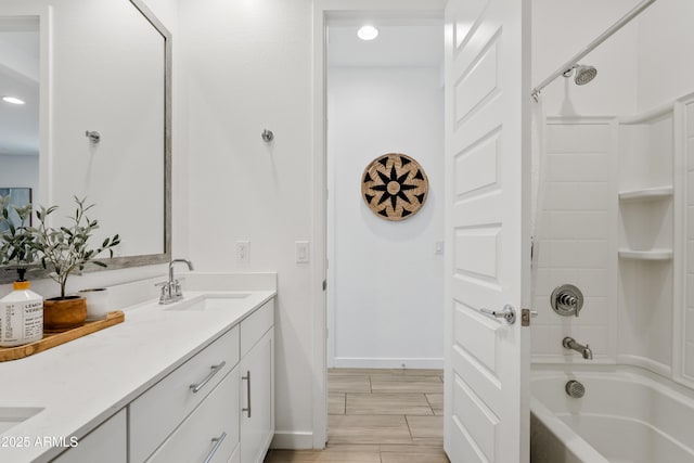 2204 E Kelly Dr, Gilbert, AZ 85298 - bathroom featuring shower / bathing tub combination, baseboards, a sink, double vanity, and wood tiled floor