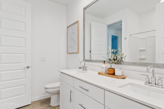 2204 E Kelly Dr, Gilbert, AZ 85298 - full bath featuring toilet, a sink, double vanity, and wood finished floors