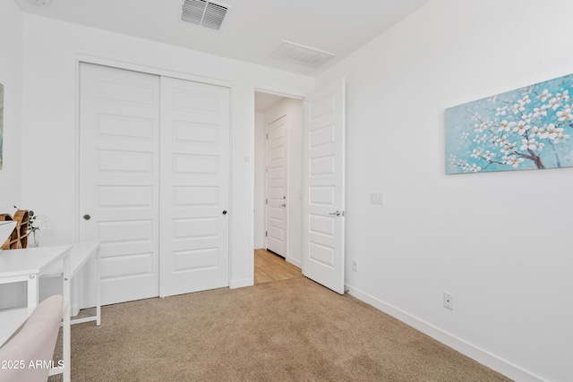 2204 E Kelly Dr, Gilbert, AZ 85298 - unfurnished bedroom with baseboards, a closet, light colored carpet, and visible vents