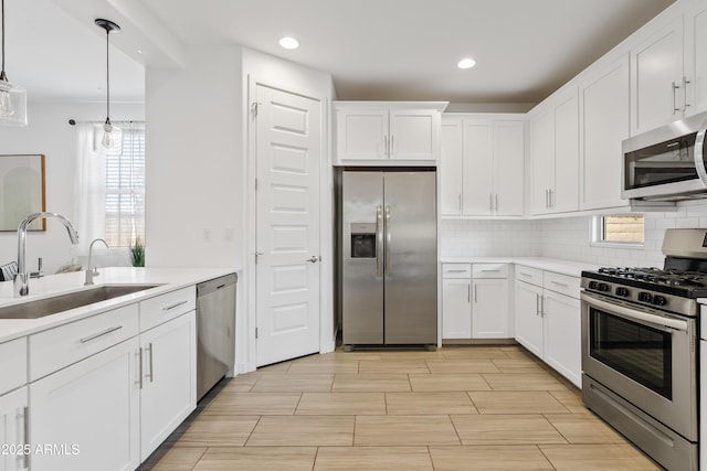 2204 E Kelly Dr, Gilbert, AZ 85298 - kitchen featuring decorative backsplash, white cabinets, light countertops, appliances with stainless steel finishes, and a sink