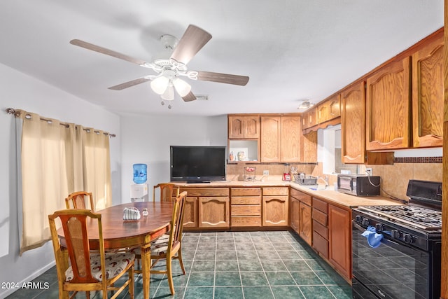 kitchen featuring decorative backsplash, gas stove, and ceiling fan