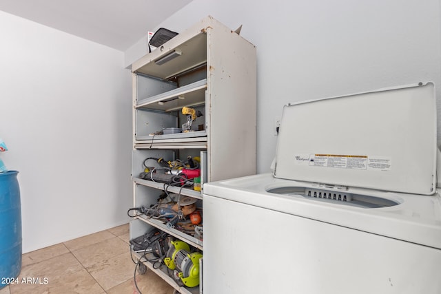 clothes washing area featuring light tile patterned flooring and washer / dryer