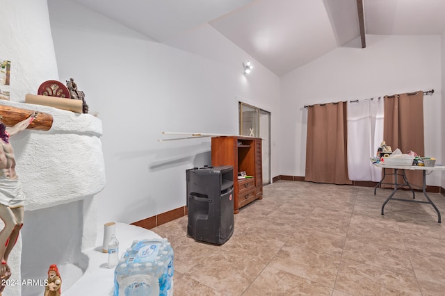 interior space featuring lofted ceiling with beams