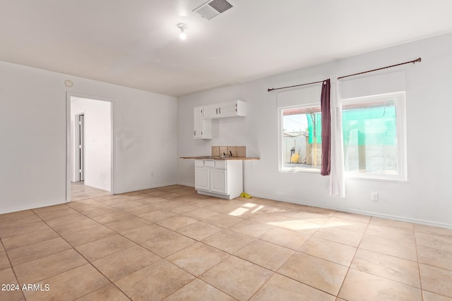 unfurnished living room with light tile patterned floors