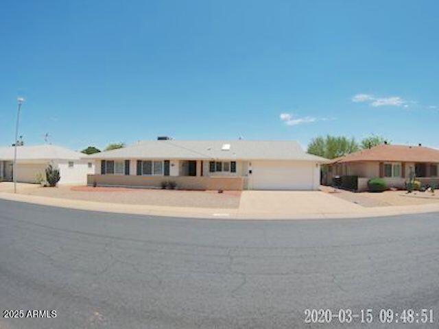 14409 N Mcphee Dr, Sun City, AZ 85351 - ranch-style house featuring an attached garage and driveway