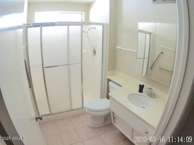 14409 N Mcphee Dr, Sun City, AZ 85351 - full bath with a stall shower, tile patterned floors, toilet, and vanity