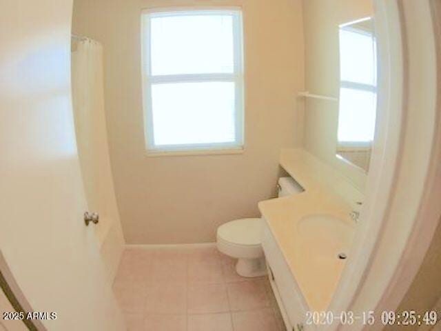 14409 N Mcphee Dr, Sun City, AZ 85351 - full bathroom with toilet, tile patterned floors, vanity, baseboards, and a shower with shower curtain