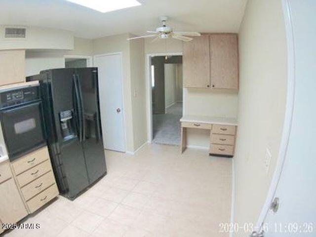 14409 N Mcphee Dr, Sun City, AZ 85351 - kitchen with black appliances, ceiling fan, baseboards, and light countertops