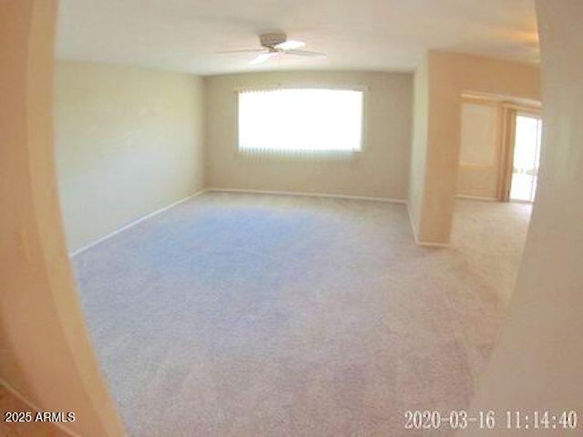 14409 N Mcphee Dr, Sun City, AZ 85351 - carpeted spare room with a ceiling fan and baseboards