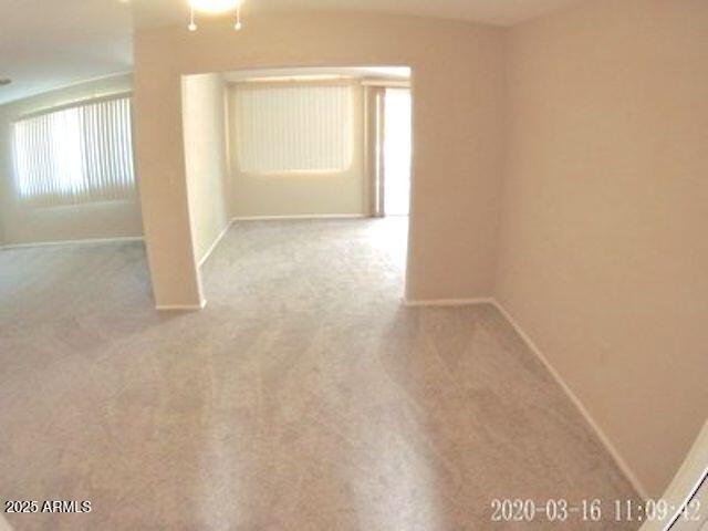 14409 N Mcphee Dr, Sun City, AZ 85351 - carpeted spare room featuring baseboards