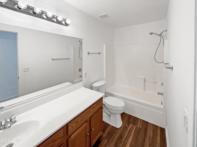 full bathroom with toilet, vanity, bathtub / shower combination, and hardwood / wood-style flooring