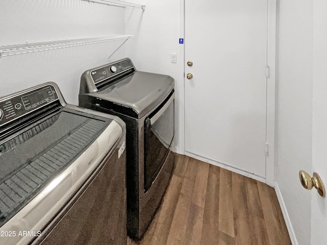 washroom featuring hardwood / wood-style flooring and washer and clothes dryer