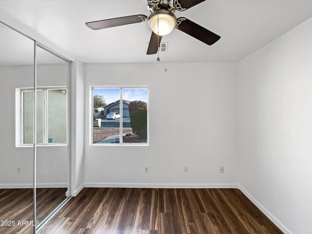 unfurnished bedroom with a closet, ceiling fan, and dark hardwood / wood-style floors