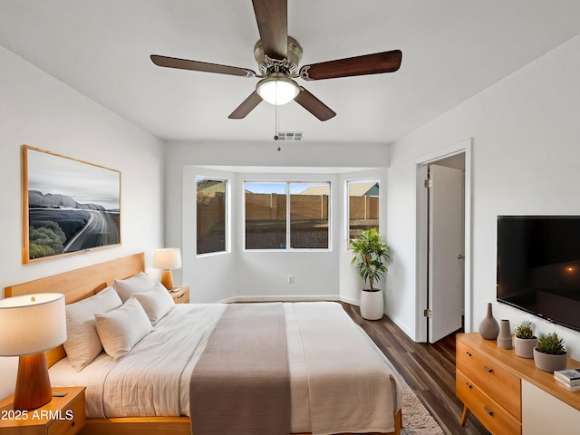 bedroom with ceiling fan and dark hardwood / wood-style floors