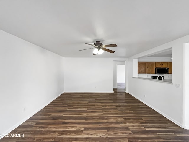 empty room featuring ceiling fan and dark hardwood / wood-style floors