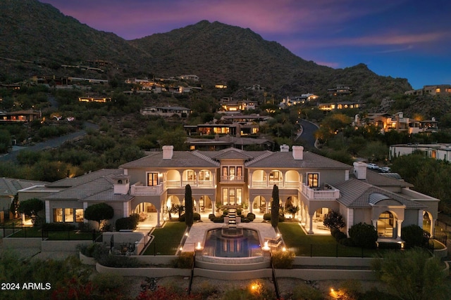 view of front of house featuring a mountain view and a balcony