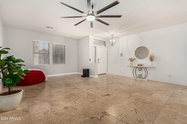 unfurnished living room with light tile patterned floors and ceiling fan