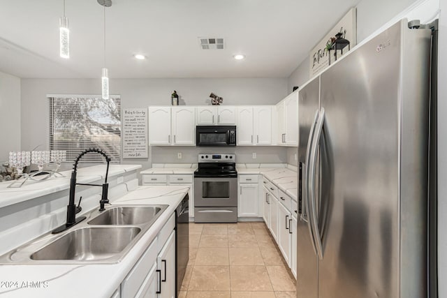 kitchen with white cabinets, decorative light fixtures, black appliances, sink, and light tile patterned flooring