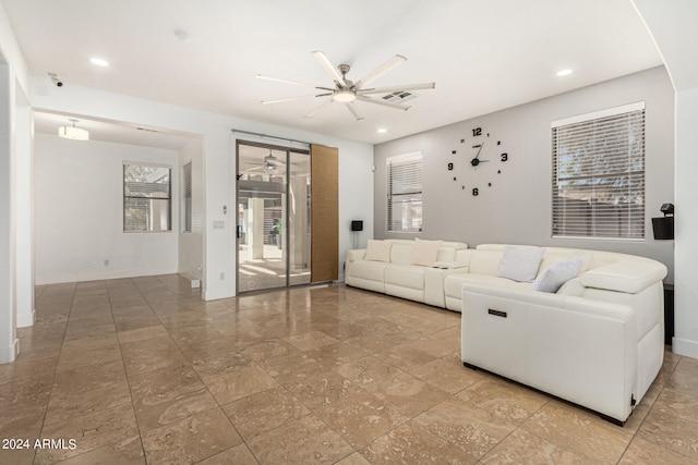 tiled living room with ceiling fan