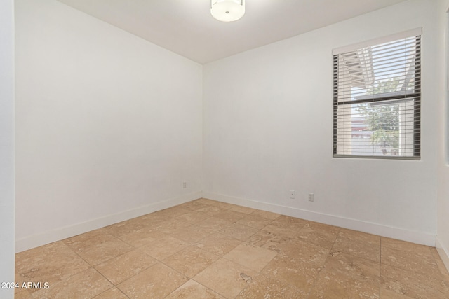 unfurnished room featuring light tile patterned floors