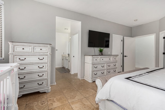 bedroom featuring light tile patterned floors and ensuite bathroom