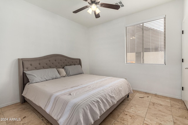 bedroom featuring light tile patterned floors and ceiling fan