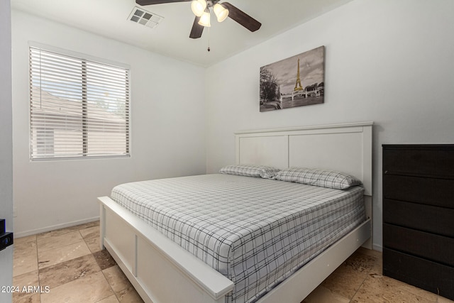 tiled bedroom featuring ceiling fan