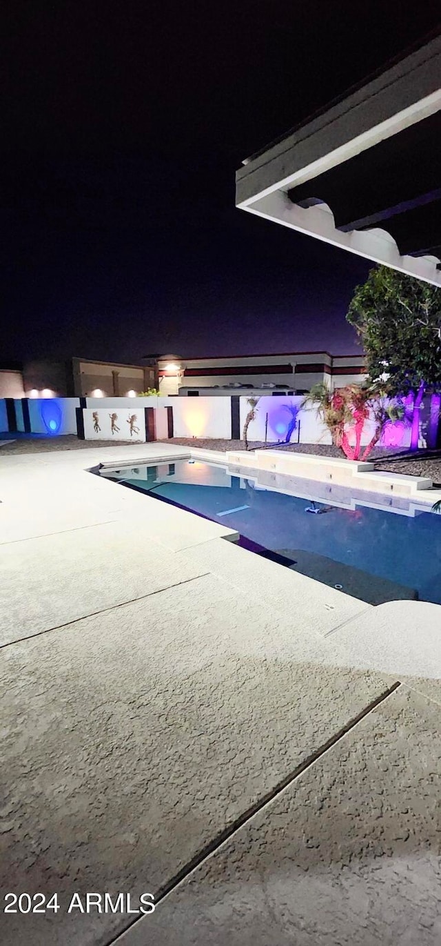 view of pool at night