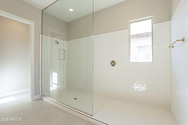 bathroom with an enclosed shower and tile patterned floors