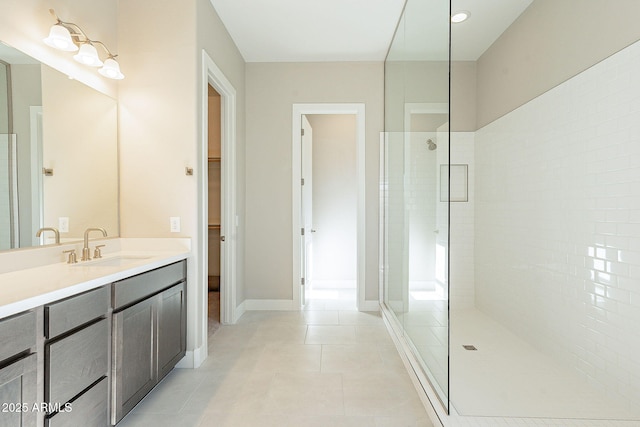 bathroom featuring vanity, a shower with shower door, and tile patterned flooring