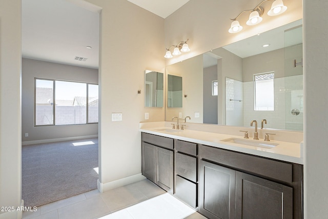 bathroom with tile patterned floors, vanity, and a shower