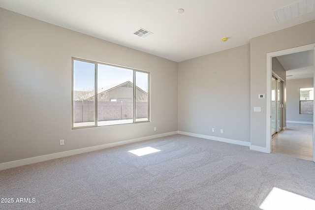 unfurnished room featuring light colored carpet