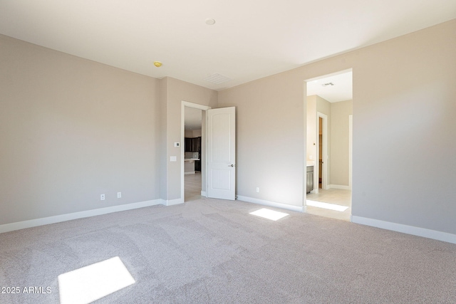 unfurnished bedroom with light carpet and ensuite bathroom