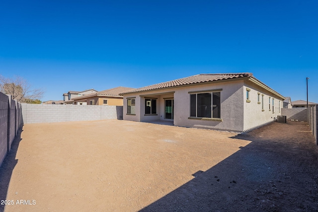 rear view of property featuring central AC unit and a patio area