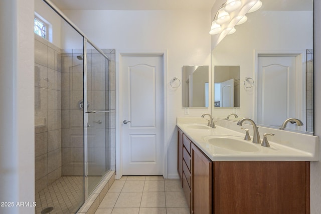 bathroom with a shower with door, tile patterned floors, and vanity