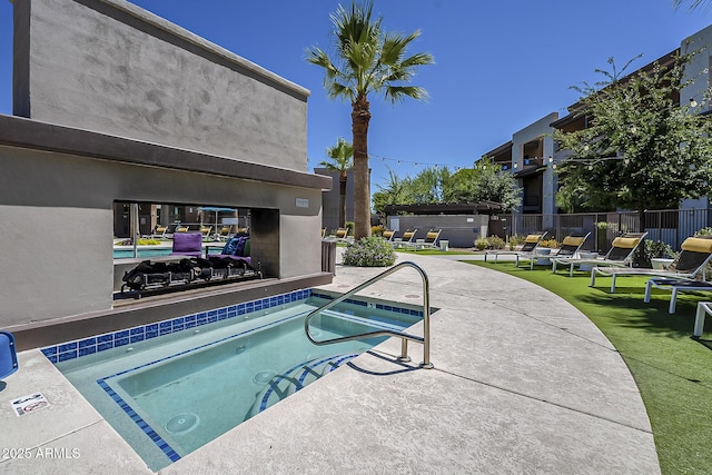 view of swimming pool with a patio and a hot tub