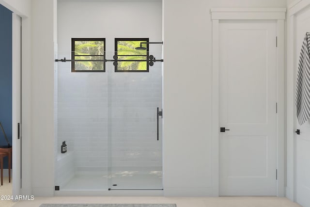 bathroom with a shower with shower door