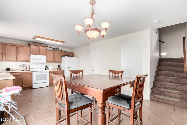 tiled dining area with a notable chandelier