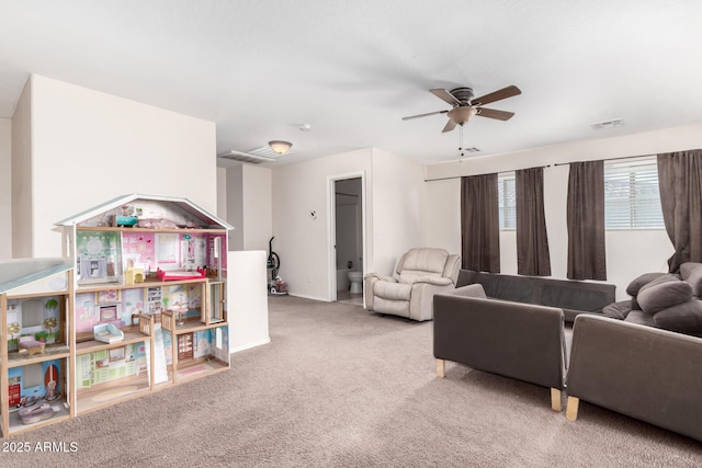 carpeted living room with ceiling fan